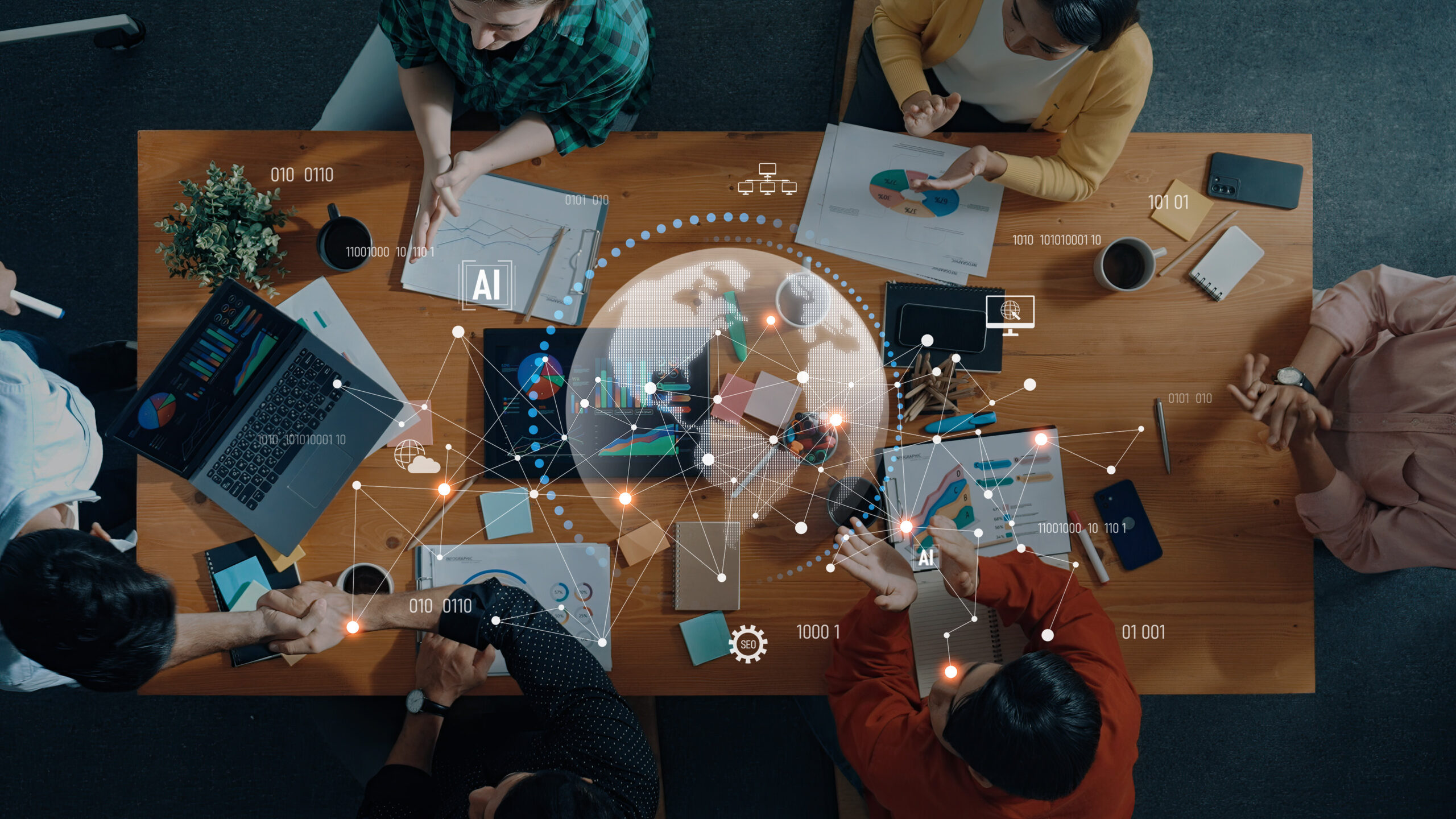 Business Team Collaborating on Data Analysis and Artificial Intelligence Strategies in Modern Office Environment During Meeting Trope Top-down view of a diverse team around a wooden table: charts, laptops, notebooks, and graphs with an AI data overlay (world map).