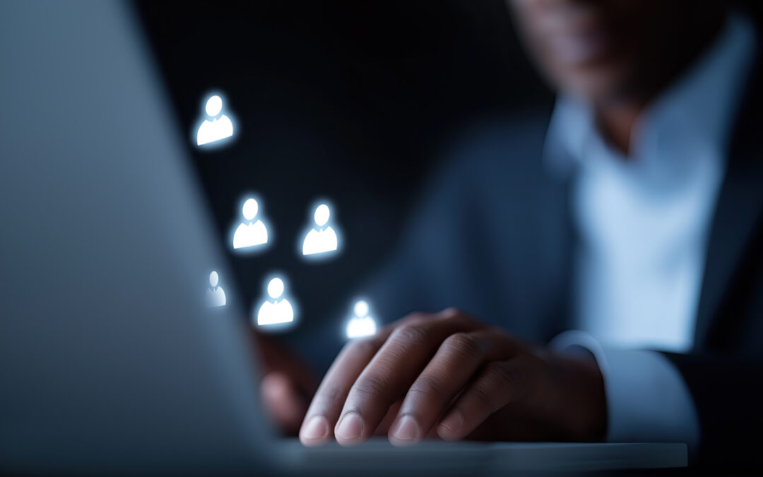 Hands typing on a keyboard with glowing user icons floating above, symbolizing online teamwork.